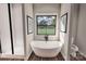 Modern bathroom features a soaking tub, rainfall shower, and bright natural light at 000 Ridgecrest Rd # 10, Locust, NC 28097