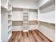 This walk-in closet features ample shelving and wood-look flooring, perfect for organization at 000 Ridgecrest Rd # 10, Locust, NC 28097