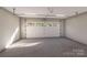 Spacious two car garage featuring overhead lighting and a large garage door with glass inserts at 000 Ridgecrest Rd # 10, Locust, NC 28097