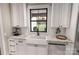 Featuring a stainless steel dishwasher and refrigerator, a farmhouse sink, white cabinets, and granite countertops at 000 Ridgecrest Rd # 10, Locust, NC 28097