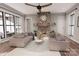 The living room is bright and spacious with large windows, hardwood floors, and a cozy fireplace at 000 Ridgecrest Rd # 10, Locust, NC 28097