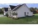 Well-maintained lawn, landscaping, and a rear-view of the back porch and side entrance of this property at 000 Ridgecrest Rd # 10, Locust, NC 28097