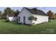 This home features beautiful landscaping with trees, flowers, and green grass, and a welcoming rear patio at 000 Ridgecrest Rd # 10, Locust, NC 28097
