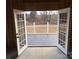 Unfinished basement with French doors leading to backyard deck at 106 Gilliatt St, Shelby, NC 28150