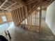 Unfinished basement with framed staircase and ample storage space at 106 Gilliatt St, Shelby, NC 28150