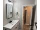 Clean bathroom with a modern vanity, black matte fixtures and a mirror at 106 Gilliatt St, Shelby, NC 28150