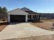 Modern home with a dark brown garage door and a long driveway at 106 Gilliatt St, Shelby, NC 28150