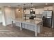 Modern kitchen boasts granite countertops, stainless steel appliances, and an island at 106 Gilliatt St, Shelby, NC 28150
