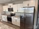 White shaker cabinets, granite countertops, and stainless steel appliances at 106 Gilliatt St, Shelby, NC 28150