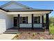 Inviting front porch featuring stylish black columns and railing with brick accents at 106 Gilliatt St, Shelby, NC 28150