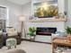 Living room with fireplace, hardwood floors, and large TV at 1133 Hidden Brook Ln, Clover, SC 29710