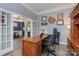 Home office with wood desk and French doors at 1203 Janrose Nw Ct, Concord, NC 28027