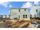 House exterior showcasing a patio, fire pit, and neighboring houses at 128 Shay Crossing Rd, Salisbury, NC 28146