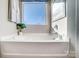 Bright bathroom with a modern tub, large window, and neutral decor at 128 Shay Crossing Rd, Salisbury, NC 28146