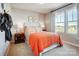Well-lit bedroom featuring large windows and stylish orange bedding at 128 Shay Crossing Rd, Salisbury, NC 28146