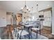 Chic dining area with modern chandelier, table setting, and wood floors at 128 Shay Crossing Rd, Salisbury, NC 28146
