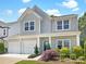Charming home with a two-car garage and manicured landscaping offers appealing curb appeal at 128 Shay Crossing Rd, Salisbury, NC 28146