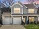 Charming two-story home featuring a three-car garage and craftsman-style details at sunset at 128 Shay Crossing Rd, Salisbury, NC 28146
