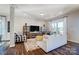 Comfortable living room with stylish black and white accents, wood flooring, and ample natural light at 128 Shay Crossing Rd, Salisbury, NC 28146