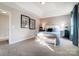 Comfortable main bedroom with a tray ceiling, soft carpet, and bedside lamps at 128 Shay Crossing Rd, Salisbury, NC 28146