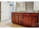 Bathroom vanity with granite countertop and dark wood cabinets at 128 Steinbeck Way # E, Mooresville, NC 28117