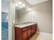 Bathroom featuring a granite countertop, wood cabinet, and a large mirror at 128 Steinbeck Way # E, Mooresville, NC 28117