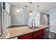 Kitchen island with granite countertop features stainless steel sink and overlooks living area at 128 Steinbeck Way # E, Mooresville, NC 28117