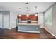 Spacious kitchen featuring stainless steel appliances, a large island, and cherry wood cabinets for ample storage at 128 Steinbeck Way # E, Mooresville, NC 28117