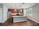 Spacious kitchen featuring stainless steel appliances, a large island, and cherry wood cabinets for ample storage at 128 Steinbeck Way # E, Mooresville, NC 28117