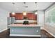Spacious kitchen featuring stainless steel appliances, a large island, and cherry wood cabinets for ample storage at 128 Steinbeck Way # E, Mooresville, NC 28117