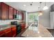 Modern kitchen features granite countertops, wood cabinets, stainless steel appliances, and a window view at 128 Steinbeck Way # E, Mooresville, NC 28117