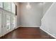 This living room has lots of natural light, tall ceilings, hardwood floors, and staircase at 128 Steinbeck Way # E, Mooresville, NC 28117
