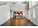 Open living room with kitchen, hardwood floors, tall ceilings, and French doors at 128 Steinbeck Way # E, Mooresville, NC 28117