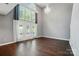 Spacious living room with tall ceilings, large windows, hardwood floors, and natural light at 128 Steinbeck Way # E, Mooresville, NC 28117