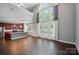 Living room with tall ceilings, lots of natural light, hardwood floors, and open floor plan at 128 Steinbeck Way # E, Mooresville, NC 28117
