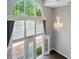 Lofted view of bright living room with cathedral ceiling and walk-out balcony at 128 Steinbeck Way # E, Mooresville, NC 28117