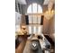 Spacious living room features a large window, hardwood floors, and a stylish chandelier at 128 Steinbeck Way # E, Mooresville, NC 28117
