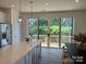 Kitchen island with seating overlooking backyard through sliding glass doors at 14016 Felix Ln # 6, Charlotte, NC 28277