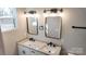 Double vanity bathroom with granite countertops and black fixtures at 1407 7Th St, Statesville, NC 28677