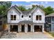 Under construction of a new modern style home with a black roof and two garage doors at 1409 Downs Ave, Charlotte, NC 28205