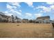 Spacious backyard featuring a patio, outdoor seating, and ample grassy area with a black metal fence at 15421 Keyes Meadow Way, Huntersville, NC 28078