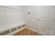 Built-in bench with storage and hooks, ideal for a mudroom at 15421 Keyes Meadow Way, Huntersville, NC 28078