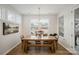 Bright dining room with hardwood floors and a wooden dining table at 15421 Keyes Meadow Way, Huntersville, NC 28078