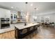 Stylish kitchen open to dining area, featuring an island with seating and stainless appliances at 15421 Keyes Meadow Way, Huntersville, NC 28078