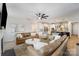 Spacious living room featuring leather sofas, modern fan, and open layout to the kitchen at 15421 Keyes Meadow Way, Huntersville, NC 28078