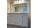 Bathroom featuring a large vanity with double sinks and a large mirror at 16721 Spinnaker Ln, Cornelius, NC 28031