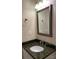 Bathroom with granite countertop, modern sink, and decorative mirror at 16721 Spinnaker Ln, Cornelius, NC 28031