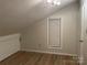 Bedroom with natural light, wood-look flooring, and a modern light fixture at 16721 Spinnaker Ln, Cornelius, NC 28031