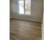 Bedroom featuring hardwood floors and a large window bringing in natural light at 16721 Spinnaker Ln, Cornelius, NC 28031