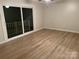 Bright, spacious bedroom with wood floor and sliding glass door to balcony at 16721 Spinnaker Ln, Cornelius, NC 28031